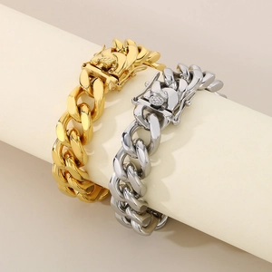 Detail of 13mm gold and silver Cuban link bracelets wrapped on a display stand