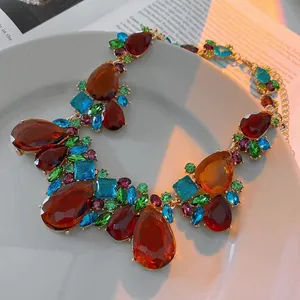 Vintage bohemian necklace featuring colorful teardrop crystals on a light gold chain