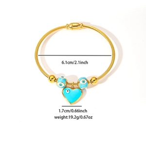 Detail of 18K gold plated steel cable bracelet with blue heart evil eye charm and beads