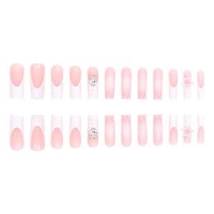 Pink and white French gradient press-on nails with 3D stars and Saturn charms