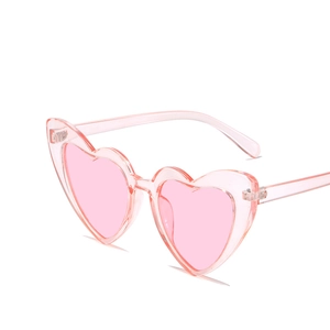 Fashionable pink heart-shaped sunglasses with glitter frame and solid tinted lenses