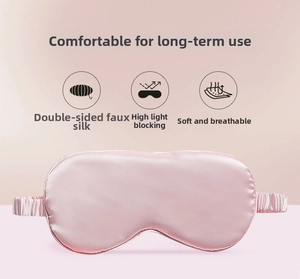 Detail of pink faux silk sleep mask showing soft glossy texture and elastic headband