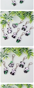 Detailed close-up of acrylic panda keychains with various poses and metal hooks