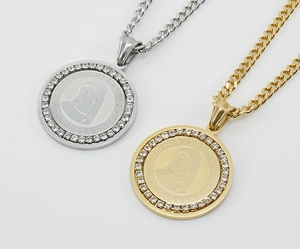 Macro view of gold and silver coin pendants with Greek meander pattern and crystal rim