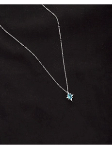 Macro view of S925 silver star pendant necklace with oval blue topaz on black background