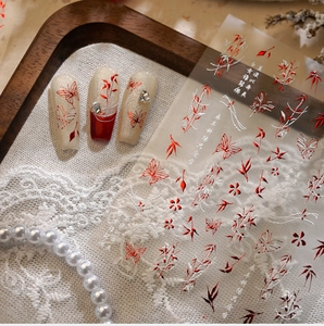 Detail of Chinese ink bamboo and butterfly nail stickers with calligraphy and pearls