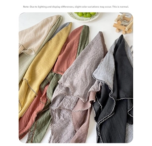 Detail of scalloped hollow crochet edges on colorful linen scarves in various shades