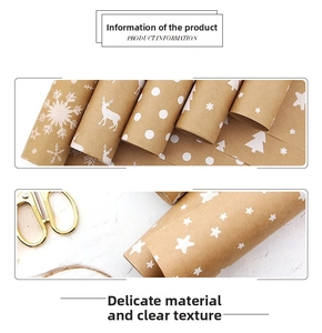 Macro shot of kraft paper gift wrap rolls with white festive reindeer and snowflake patterns
