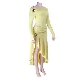 Détail d'une robe en maille jaune clair avec boucles en cœur dorées et design ajouré