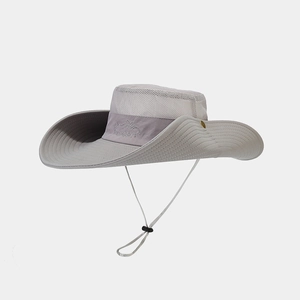 Detail of grey outdoor hat featuring breathable mesh panels and adjustable chin strap