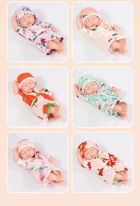Collection of six 20cm mini reborn dolls in floral bathrobes on a pink background
