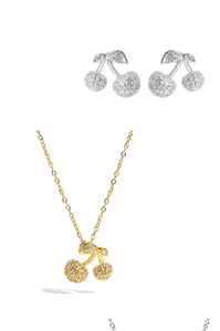 Macro detail of cherry pendant jewelry set with sparkling pavé cubic zirconia