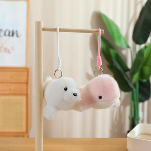 Macro view of plush dolphin and seal charms with soft fur and metal keychains