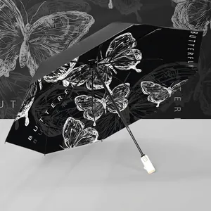 Minimalist black and white folding umbrella with hand-drawn butterfly and sun protection