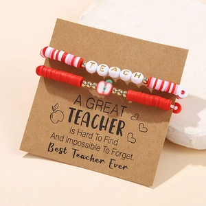 Detail of beaded teacher bracelets with TEACH lettering and apple charm on card