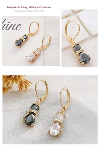 Detail of cat shaped copper earrings with sparkling cubic zirconia and lever-back hooks