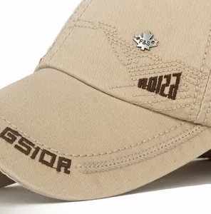 Close-up of cotton baseball cap featuring 3D letter embroidery and metal maple leaf badge