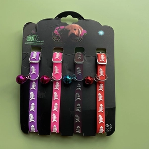 Set of four colorful silicone pet collars with fishbone pattern and bells on display cards