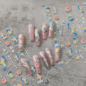 Chinese style nail art stickers with phoenix and koi motifs on pink long press-on nails