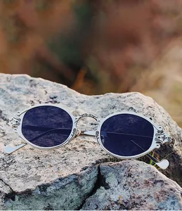 Macro detail of silver metal steampunk sunglasses frame with ornate vintage engraving