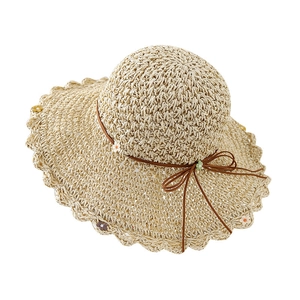 Foldable straw sun hat with bow and floral accents for beach and summer shade protection