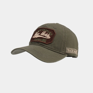 Close-up of military green cotton baseball cap with vintage embroidery and badge details