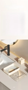 Detail view of the detachable soap box featuring a drainage rack and transparent lid