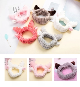 Close-up of soft coral fleece headbands with cute reindeer antlers in multiple colors