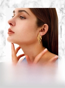 Close-up of 18K gold plated stainless steel stud earring with irregular wavy texture