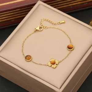 Golden stainless steel bracelet featuring tiger eye stones in floral and circular settings