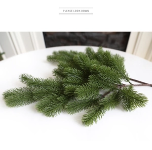 Detailed view of realistic PE pine needles branch for festive Christmas home decoration