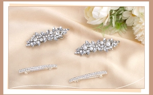 Detailed set of silver hair clips with marquise rhinestones and pearls on silk
