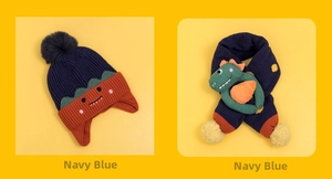 Detail of navy blue knit hat and scarf set with 3D dinosaur plush decor for kids