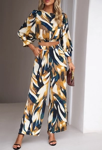 Detailed close-up of the abstract plant print on the sleeve and waist of the 2-piece set