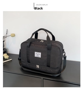Detailed view of black quilted fitness bag with separate shoe compartment and strap