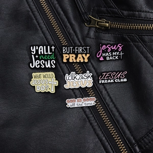 Close-up of colorful enamel religious brooches pinned on a premium black leather jacket