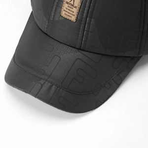 Close-up of winter baseball cap with textured fabric and a brown leather logo patch