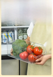Close-up of clear food-grade storage box with striped bottom and side handle cutout