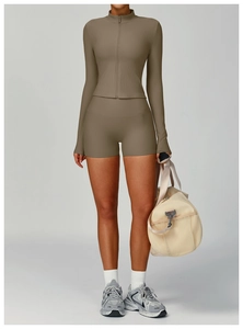Detailed texture of coffee ribbed yoga set featuring long sleeve zip top and shorts