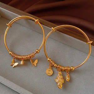 Gold plated butterfly and copper coin cuff bracelets with traditional lucky charms