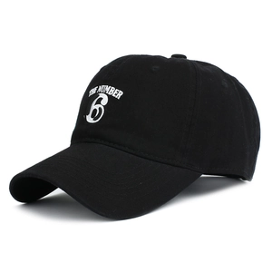 Detail of THE NUMBER 6 white embroidery on black cotton twill baseball cap