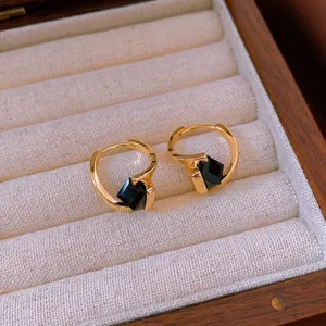 Gold-plated irregular cube hoop earrings with black stone in a jewelry box