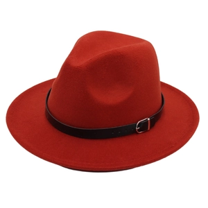 Detail of red fedora wool hat featuring black leather band and silver metal buckle