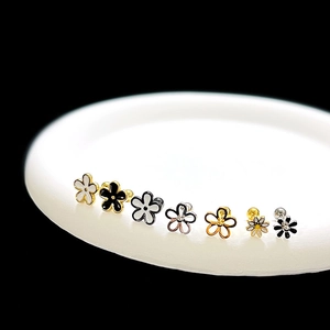 Set of minimalist 3D daisy flower earrings in gold, black, and white steel designs