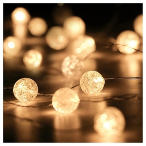Close-up of warm white LED starry string lights with crackle glass globe texture