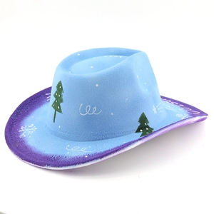 Detail of light blue felt cowboy hat featuring festive Christmas tree and snowflake patterns