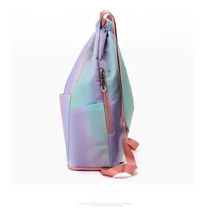 Detail of waterproof gradient drawstring backpack showing side zipper pocket and pink strap