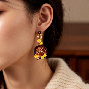 Detail of vintage flower drop earring with honeycomb pattern and Chinese Xi character