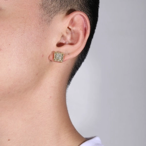 Close-up of a men's square gold earring with pavé-set clear cubic zirconia on a model