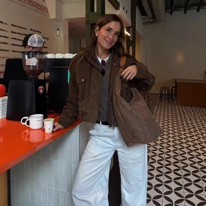 Vintage brown faux suede biker jacket styled with white wide-leg trousers and a tote bag